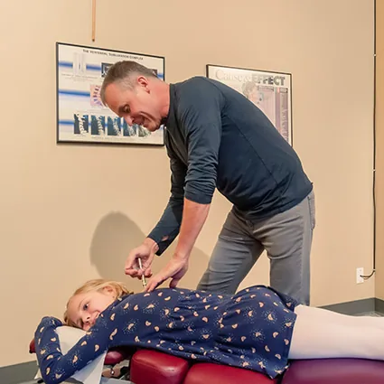 Dr. Condren Berry DC adjusting a child patient