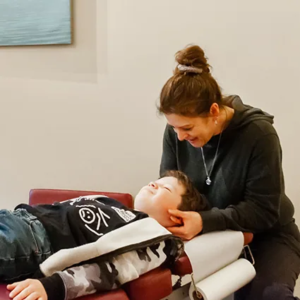 Dr. Tamara Kornelsen DC adjusting a young patient