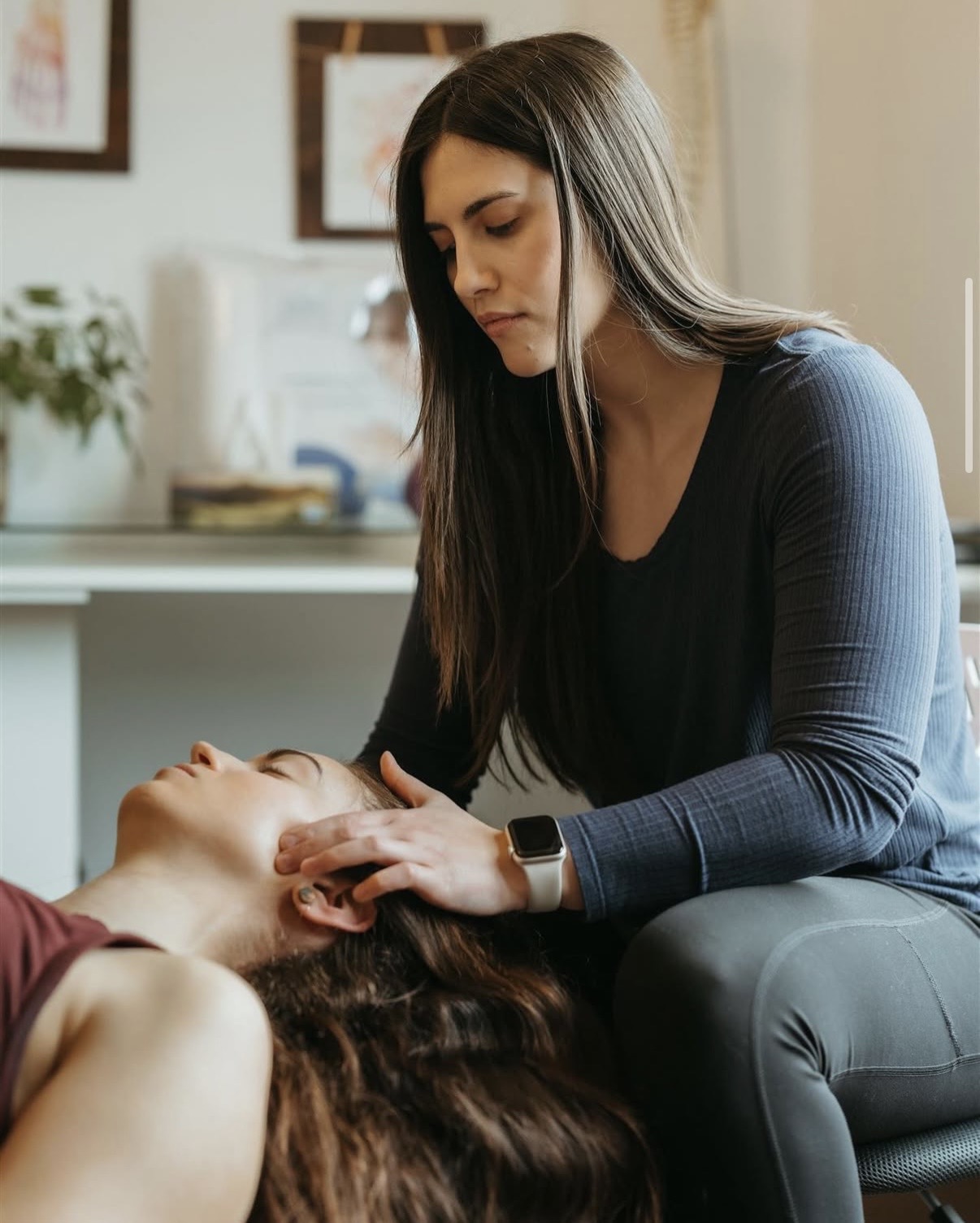 Dr. Maia Pidperyhora DC performing a cervical assessment at Okanagan Chiropractic Center Penticton BC